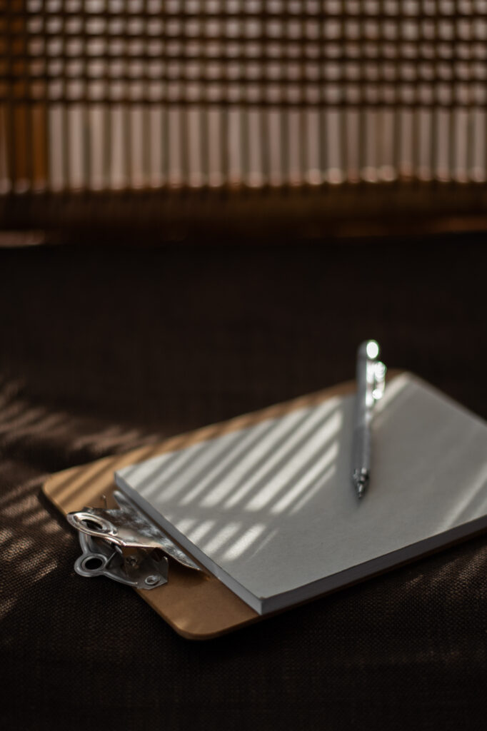 Clipboard with blank checklist paper and pen in soft natural light